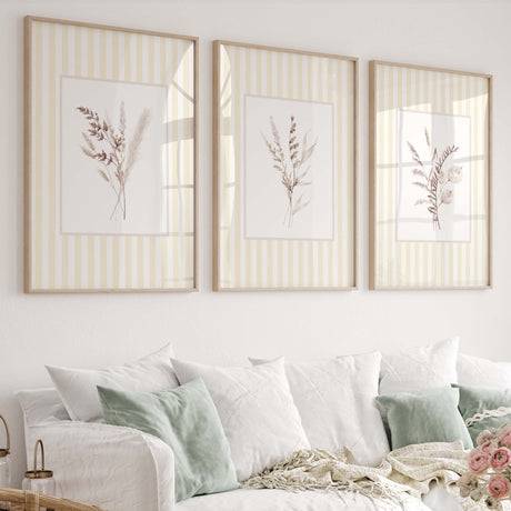 Neutral botanical wall art set of 4 with beige dried florals on yellow striped background for nursery decor