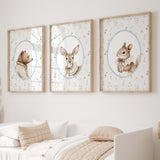 Set of three woodland animal nursery prints featuring a bear, deer, and squirrel with a wildflower background, perfect for baby room decor or nursery wall art