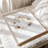 Cozy beige Christmas wreath wall print with pinecones and flowers.