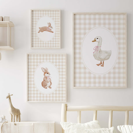 Beige bunny and duck nursery print set with pink bows and gingham background for baby girl room
