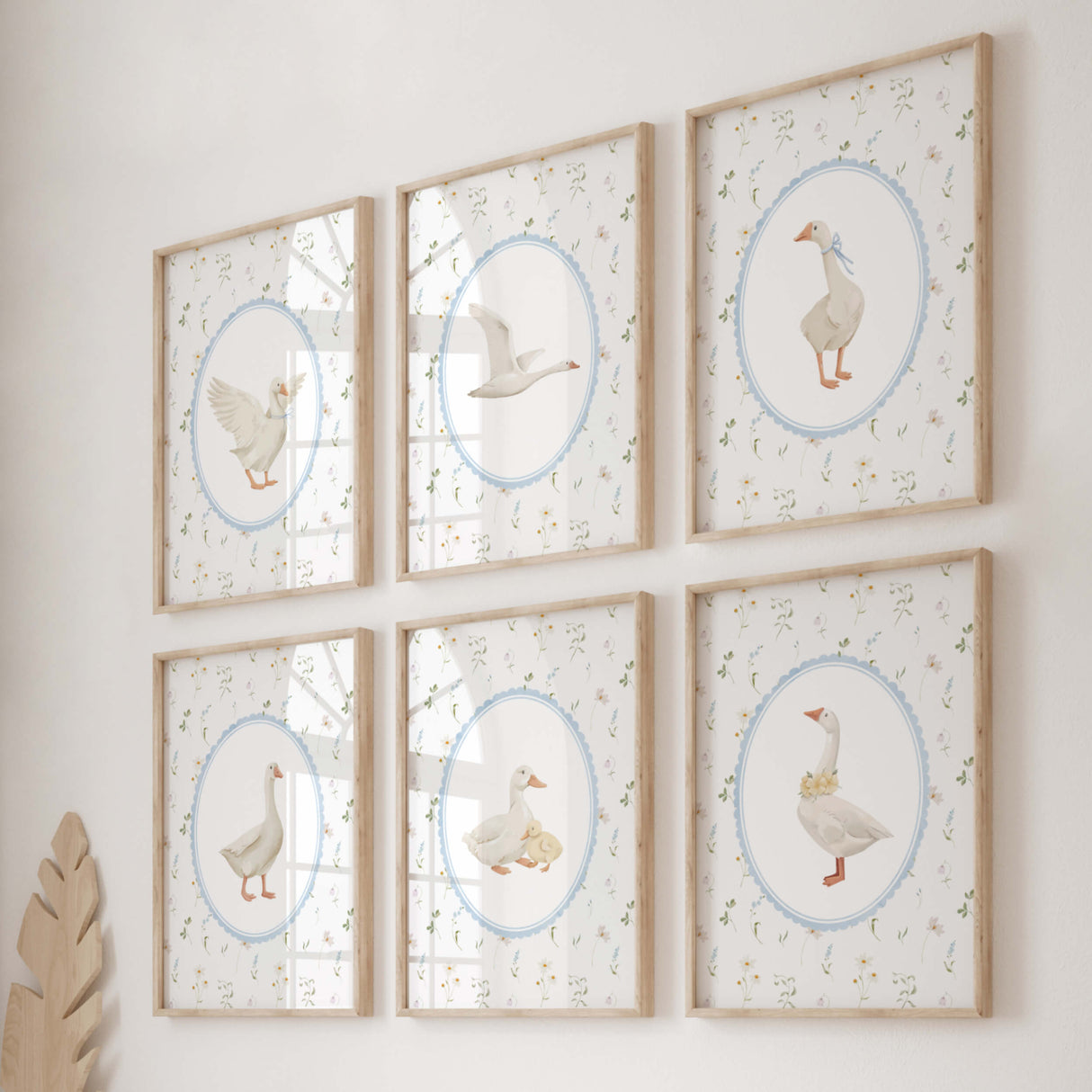 Boho nursery wall art set featuring vintage goose illustrations with wildflower backgrounds, perfect for baby room decor in neutral colors with blue accents