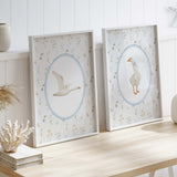 Vintage goose wall art trio for nursery, gentle watercolor style prints with blue oval borders and floral backgrounds, gender neutral baby decor