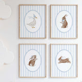 Nursery wall art with bunny and duck illustrations in pastel colors for baby boy room.

