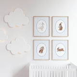 Baby nursery animal prints set with blue striped background and framed artwork.

