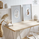 Scandinavian-style nursery wall art with watercolor bunny and goose prints.

