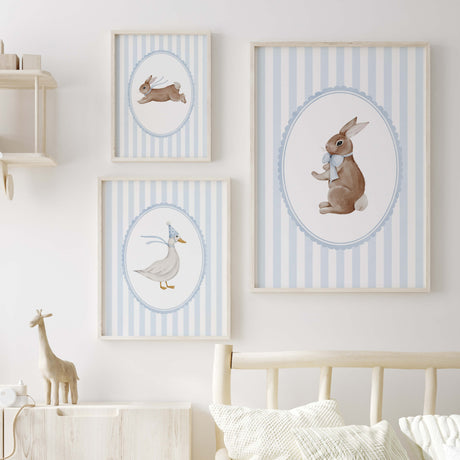 Blue nursery wall decor with baby animals in frames for gender neutral room.

