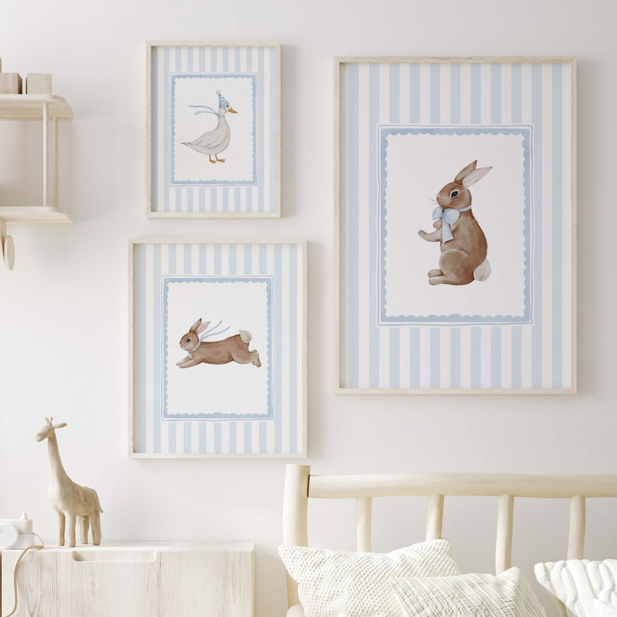 Blue nursery wall decor with baby animals in frames for gender neutral room.

