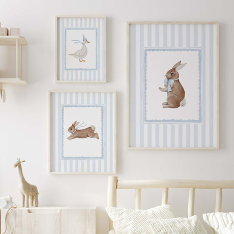 Blue nursery wall decor with baby animals in frames for gender neutral room.

