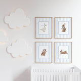 Baby nursery animal prints set with blue striped background and framed artwork.

