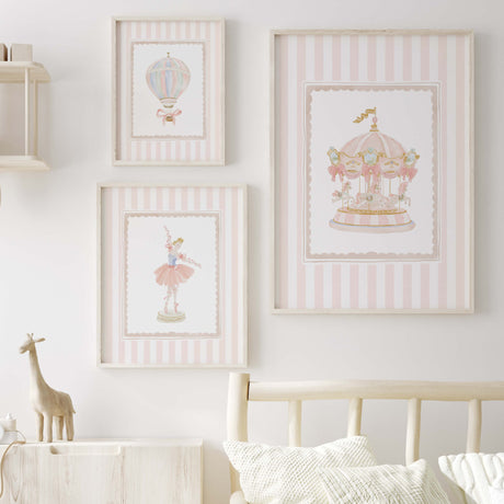 Pastel pink baby room art featuring balloon ballerina and carousel in striped frame


