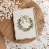 Cozy Christmas wall art with watercolor wreath and soft beige bow.