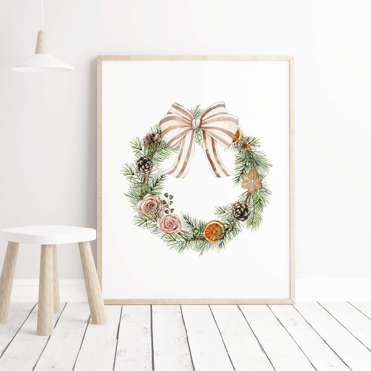 Neutral holiday printable featuring wreath with pinecones and dried oranges.