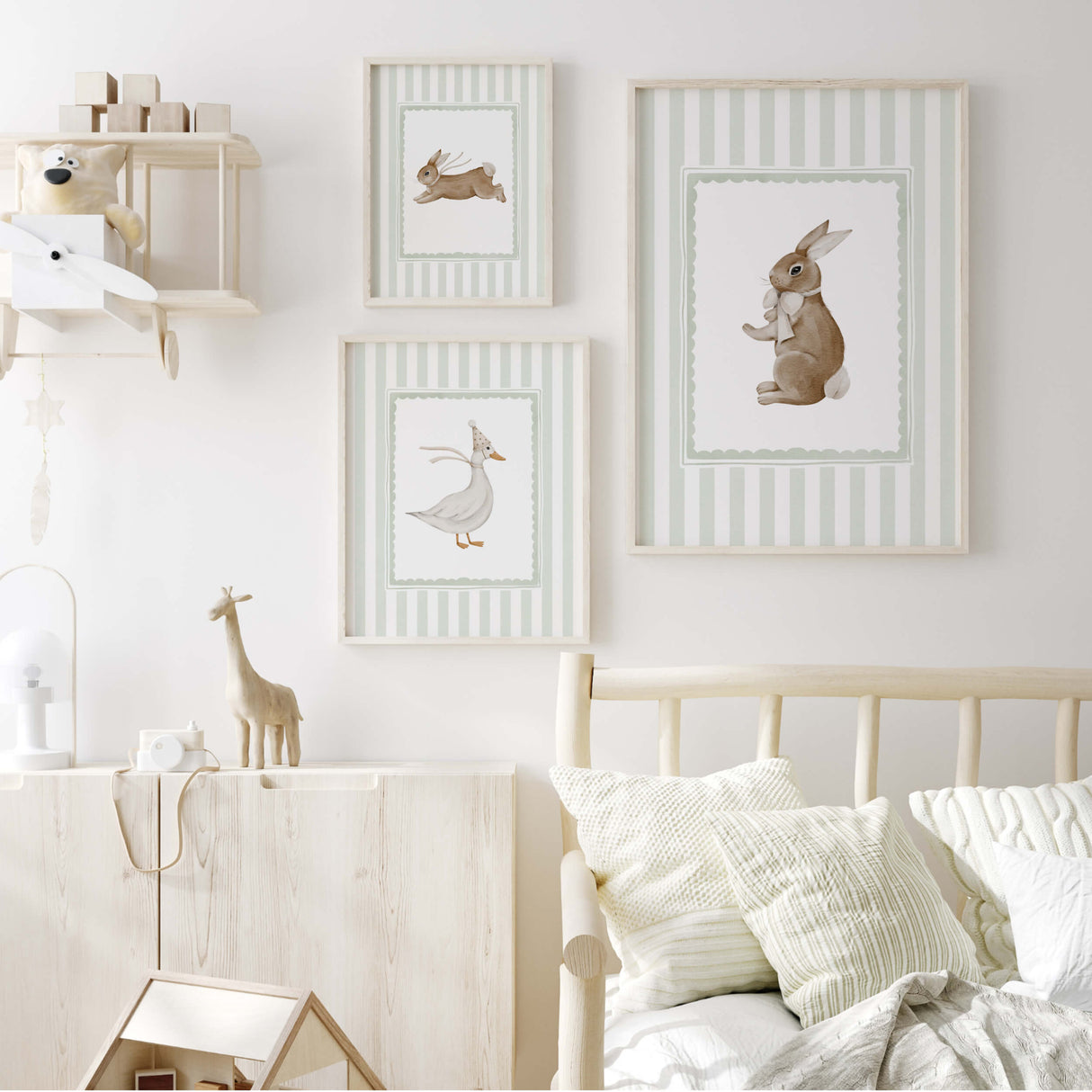 Sage green nursery wall art with bunny and duck illustrations for calming baby room.

