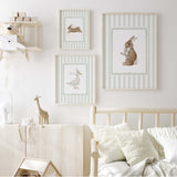 Sage green nursery wall art with bunny and duck illustrations for calming baby room.

