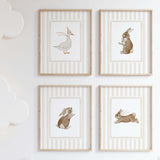 Beige nursery wall art with bunny and duck illustrations for neutral baby room.

