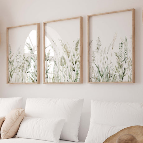 Digital printable green grass artwork in wooden frames above white couch

