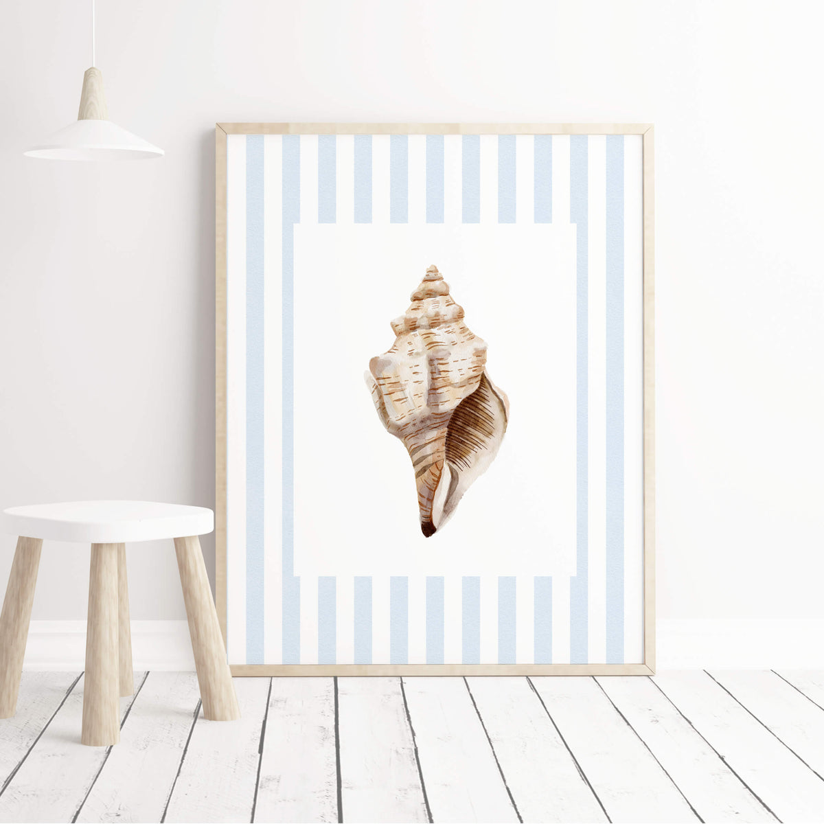 Coastal nursery wall art with blue striped backgrounds and neutral watercolor seashells for baby boy nursery decor.