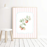 Pastel botanical kitchen decor prints with strawberries and mushroom illustrations on pink striped background.

